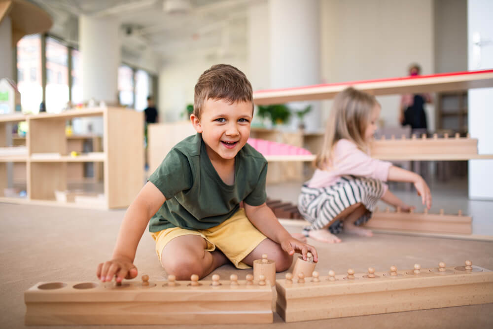 A child plays with Montessori resources. 