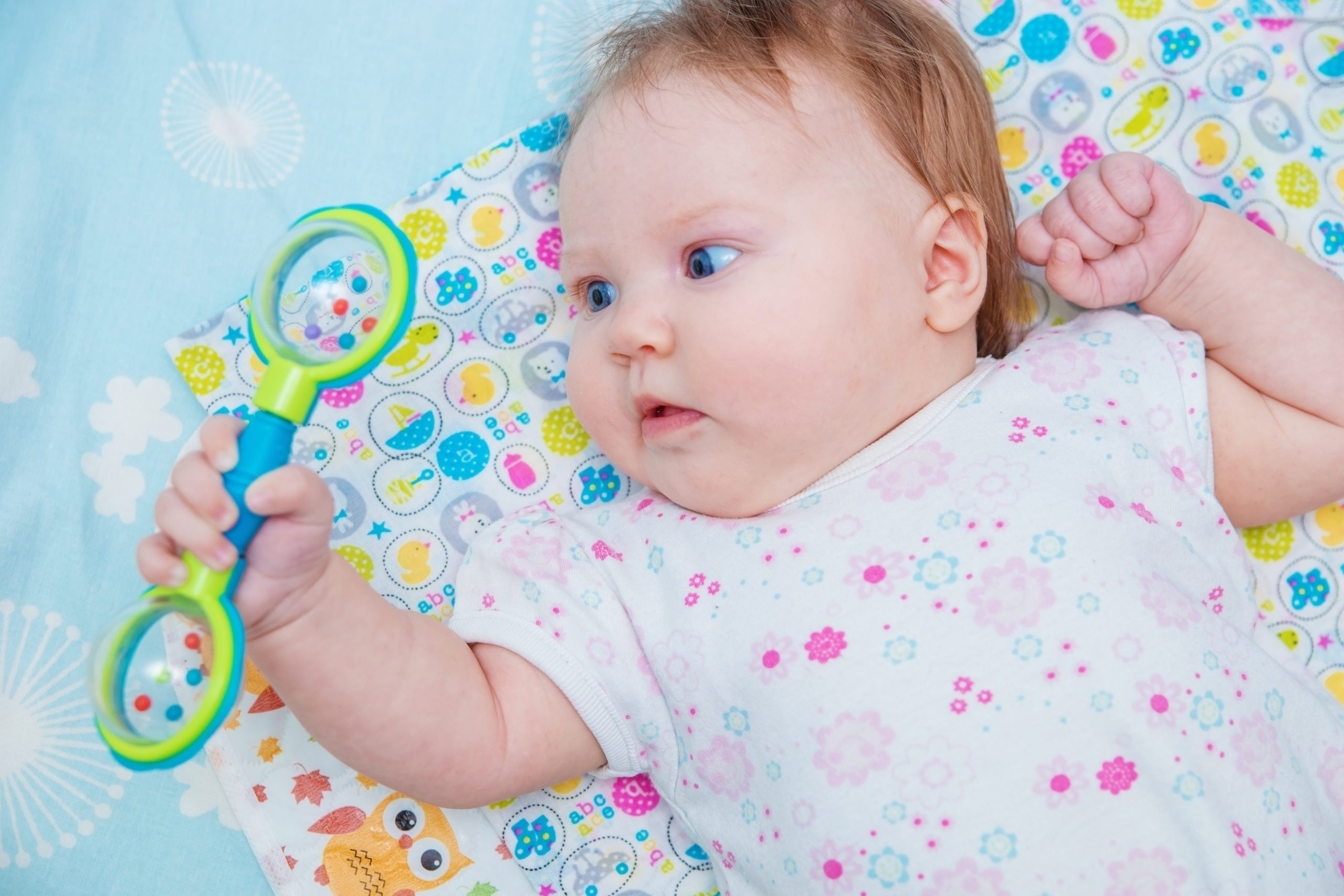 Baby with rattle in hand symbolises the first of Bruner's three modes of representation