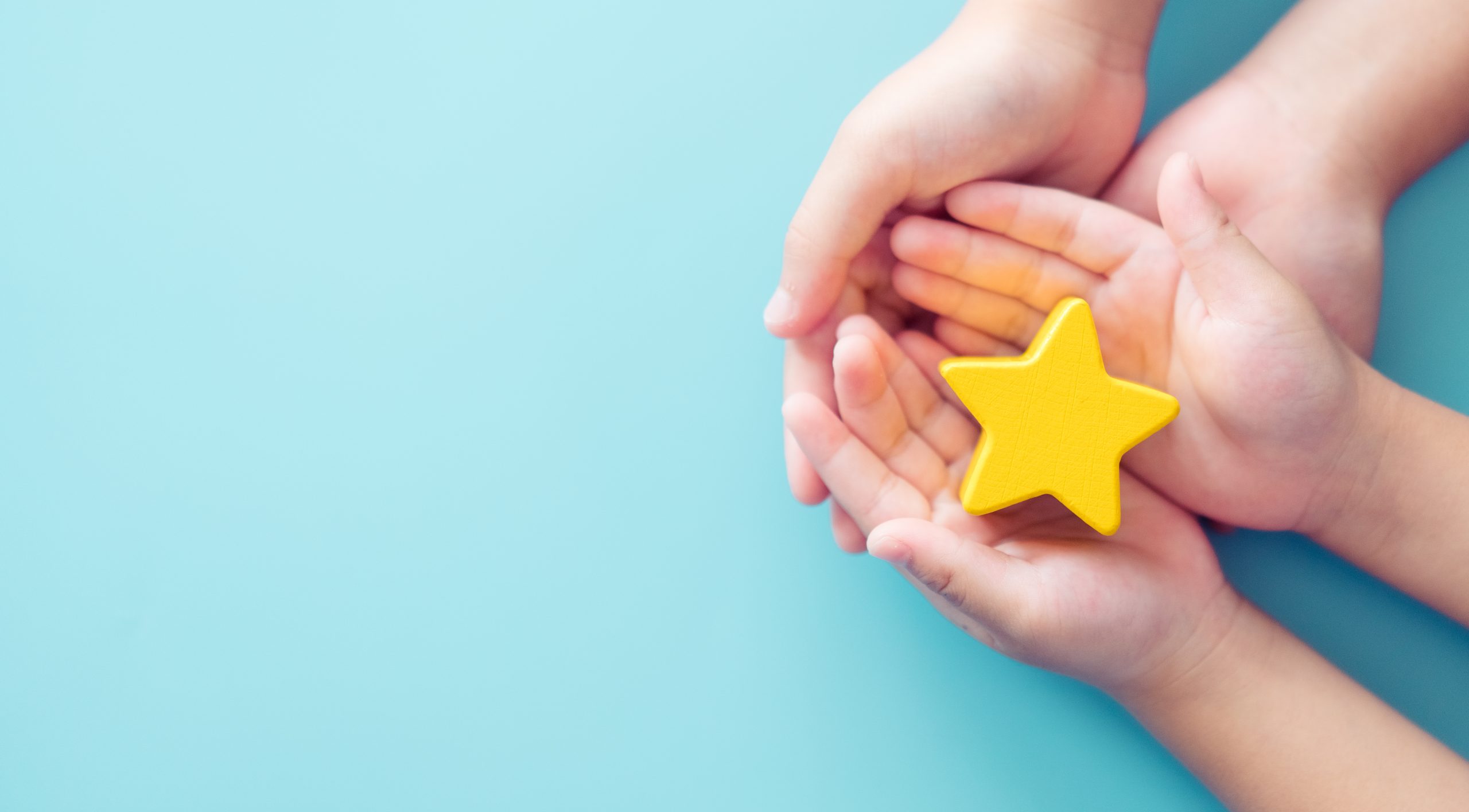 Mother giving a star rating to her child as a form of recognition for good work, highlighting family encouragement and child development.